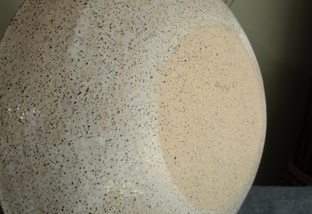 White platter/ bowl with black stones