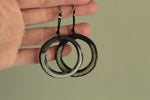 Load image into Gallery viewer, Black and beige hoop dangling earrings with cord
