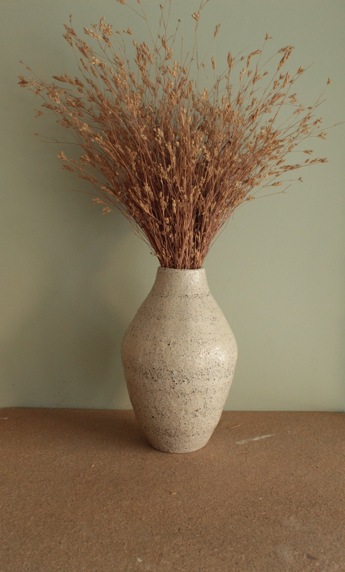 White vase with black rocks - 2