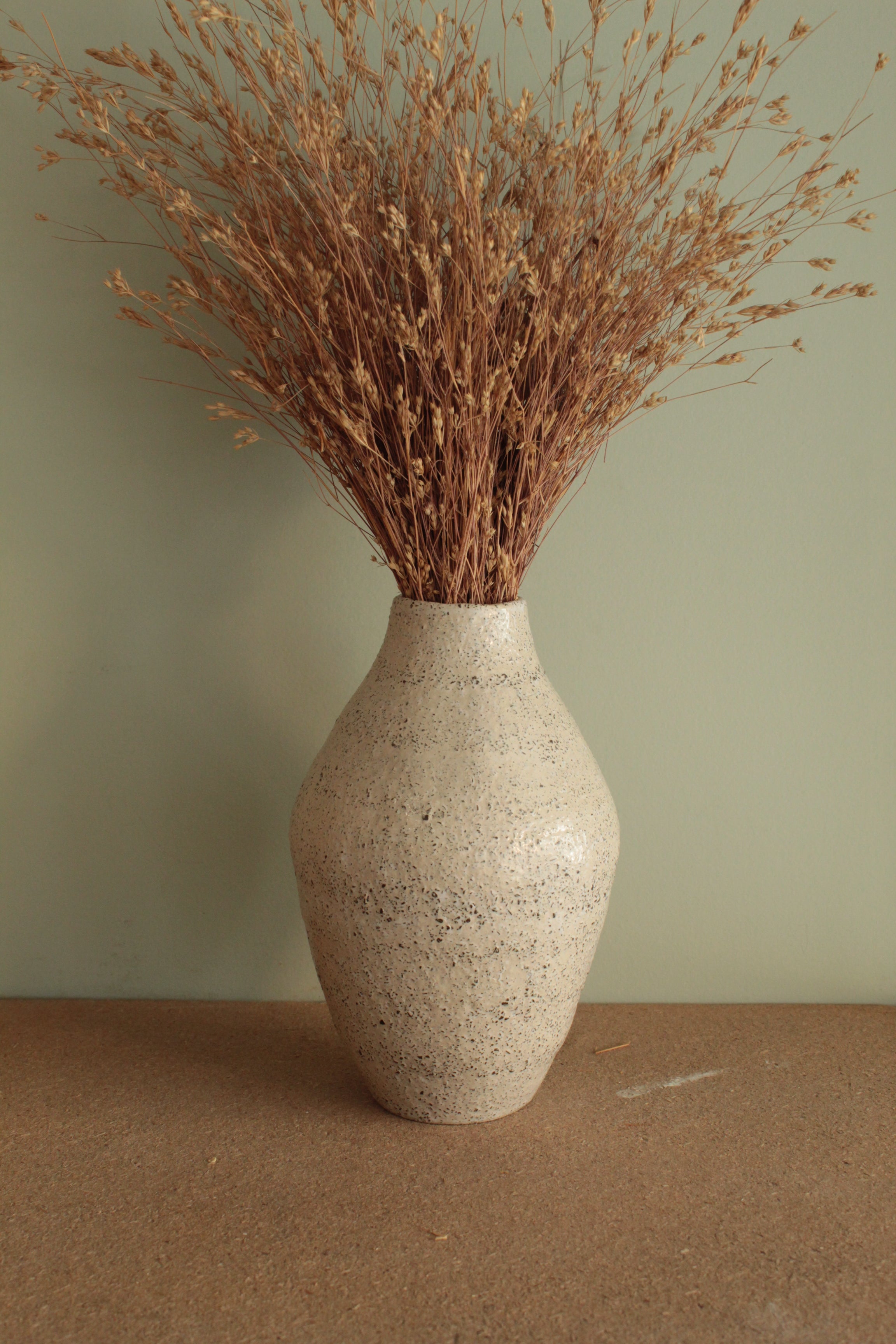 White vase with black rocks - 2
