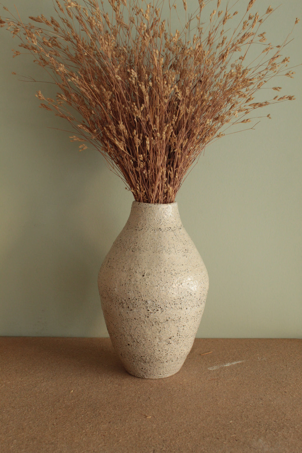 White vase with black rocks - 2