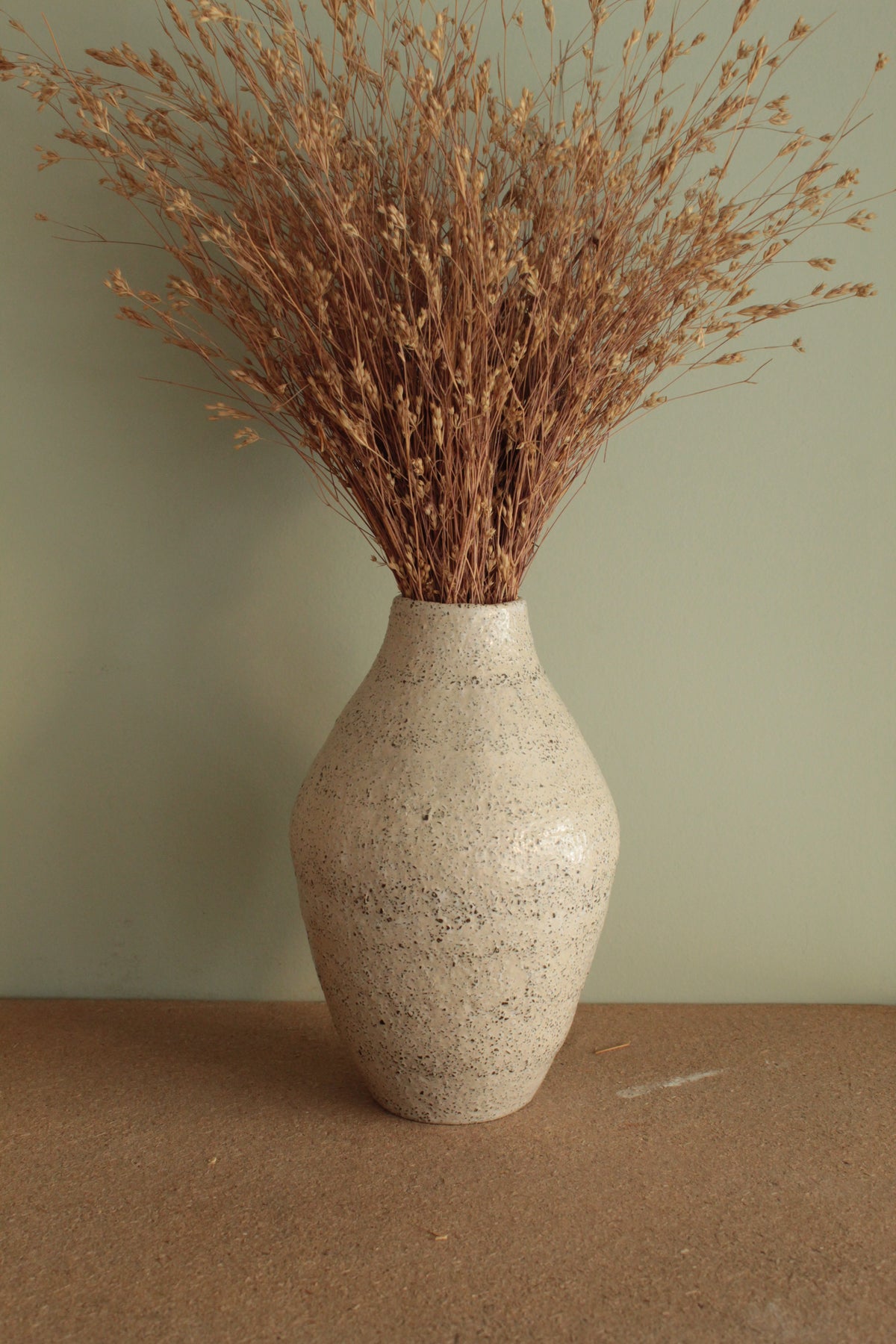 White vase with black rocks - 2