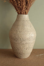 White vase with black rocks - 2