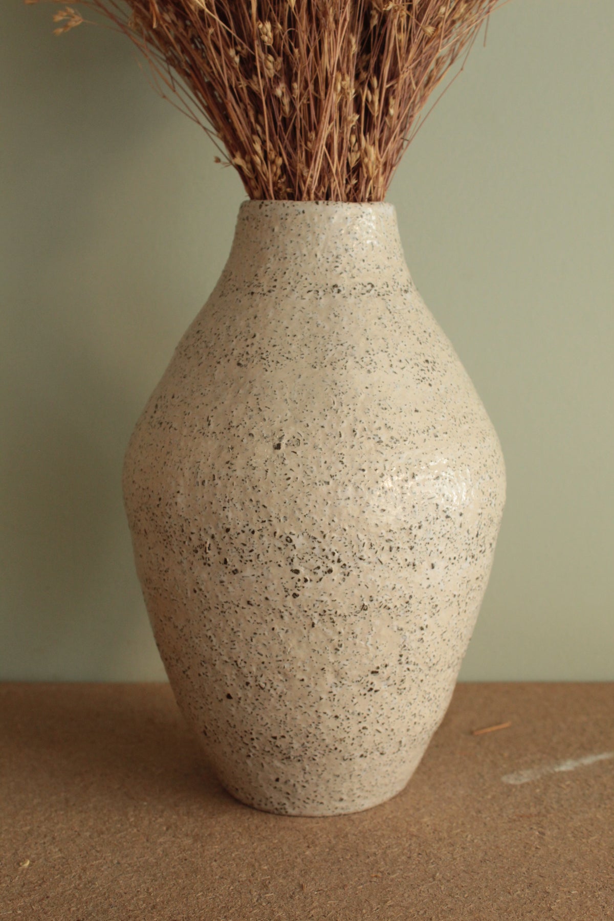 White vase with black rocks - 2