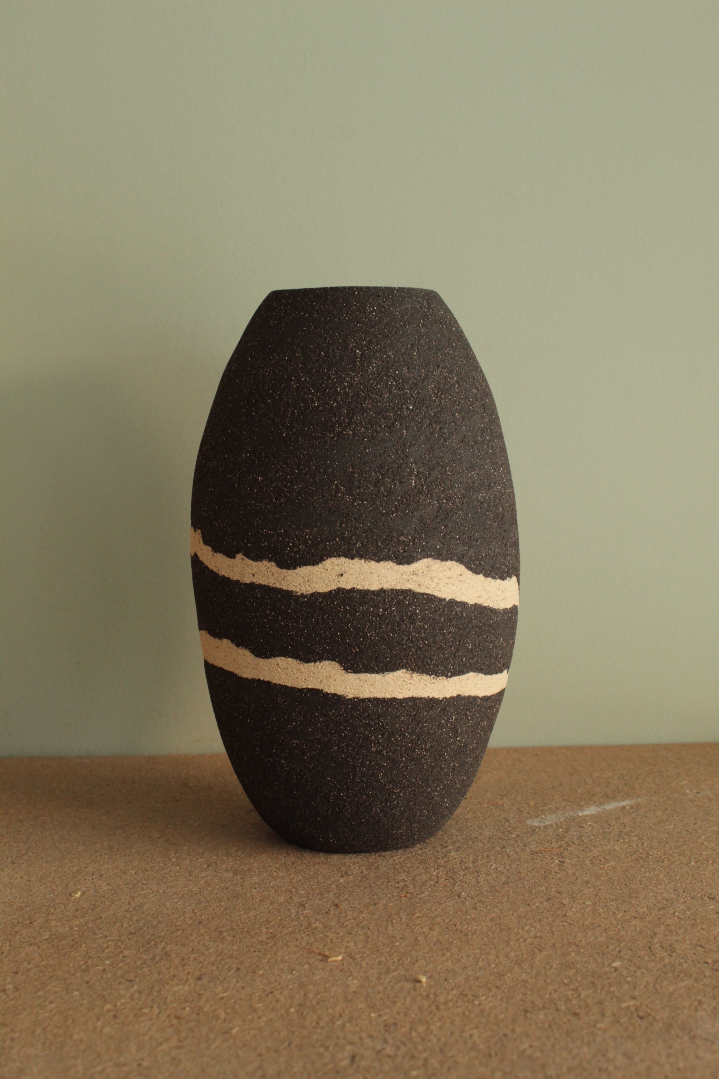 Black vase with white lines