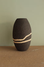 Black vase with white lines