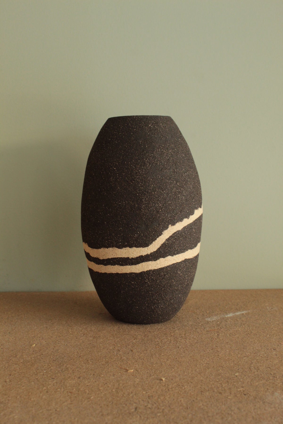 Black vase with white lines