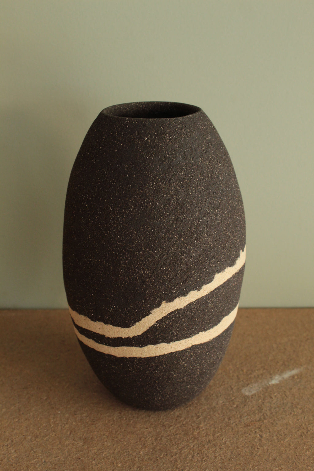 Black vase with white lines