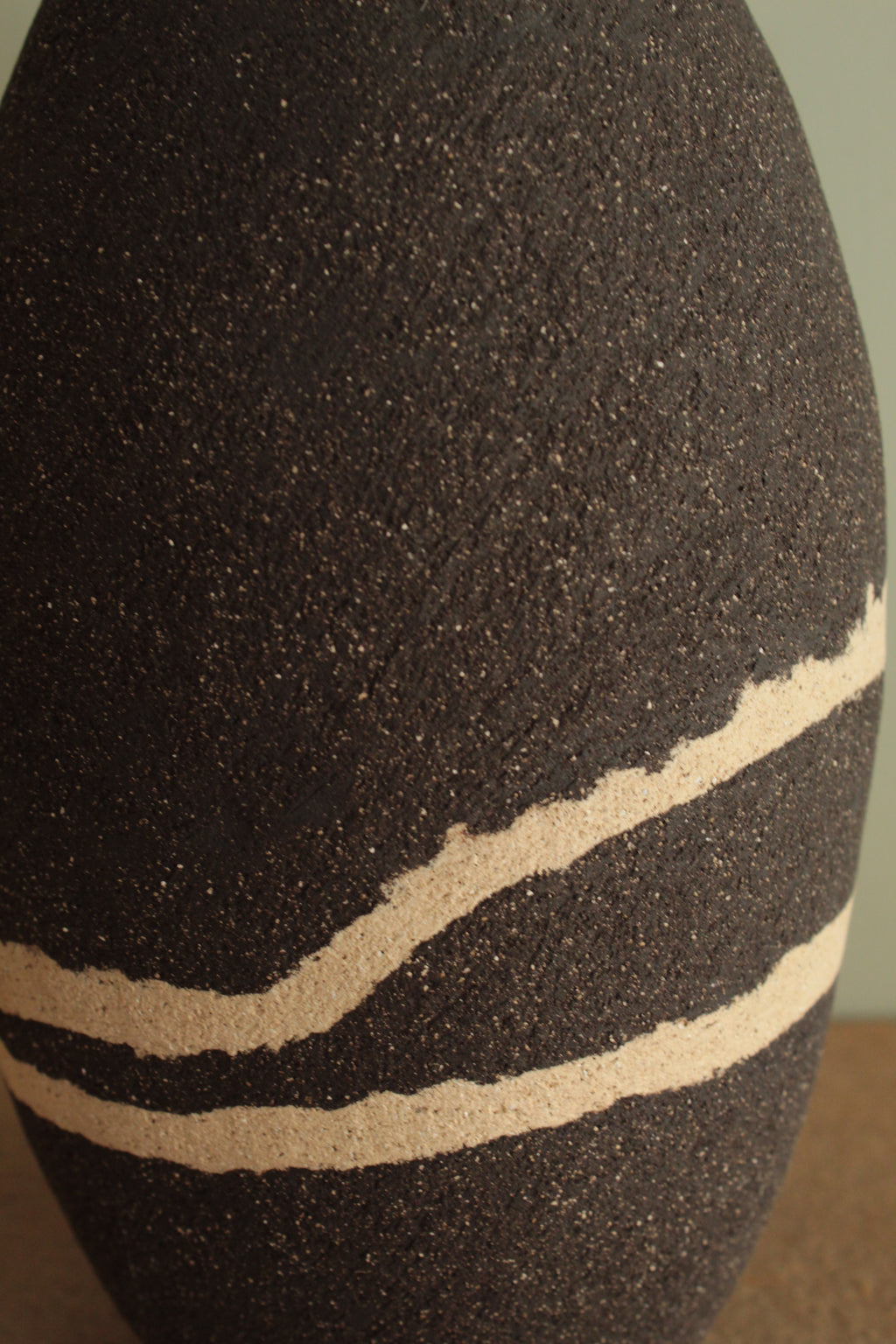 Black vase with white lines