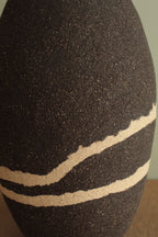 Black vase with white lines