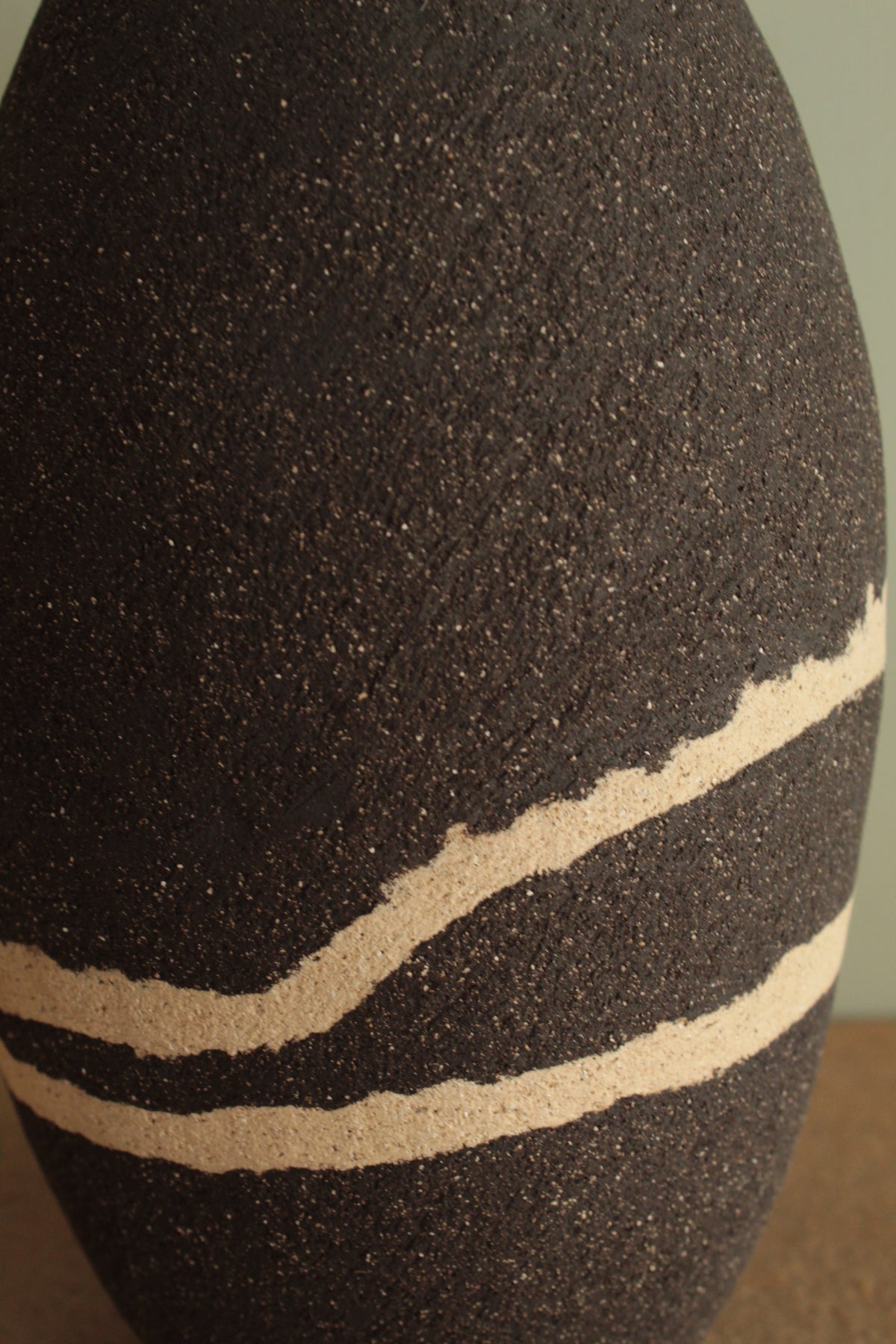 Black vase with white lines