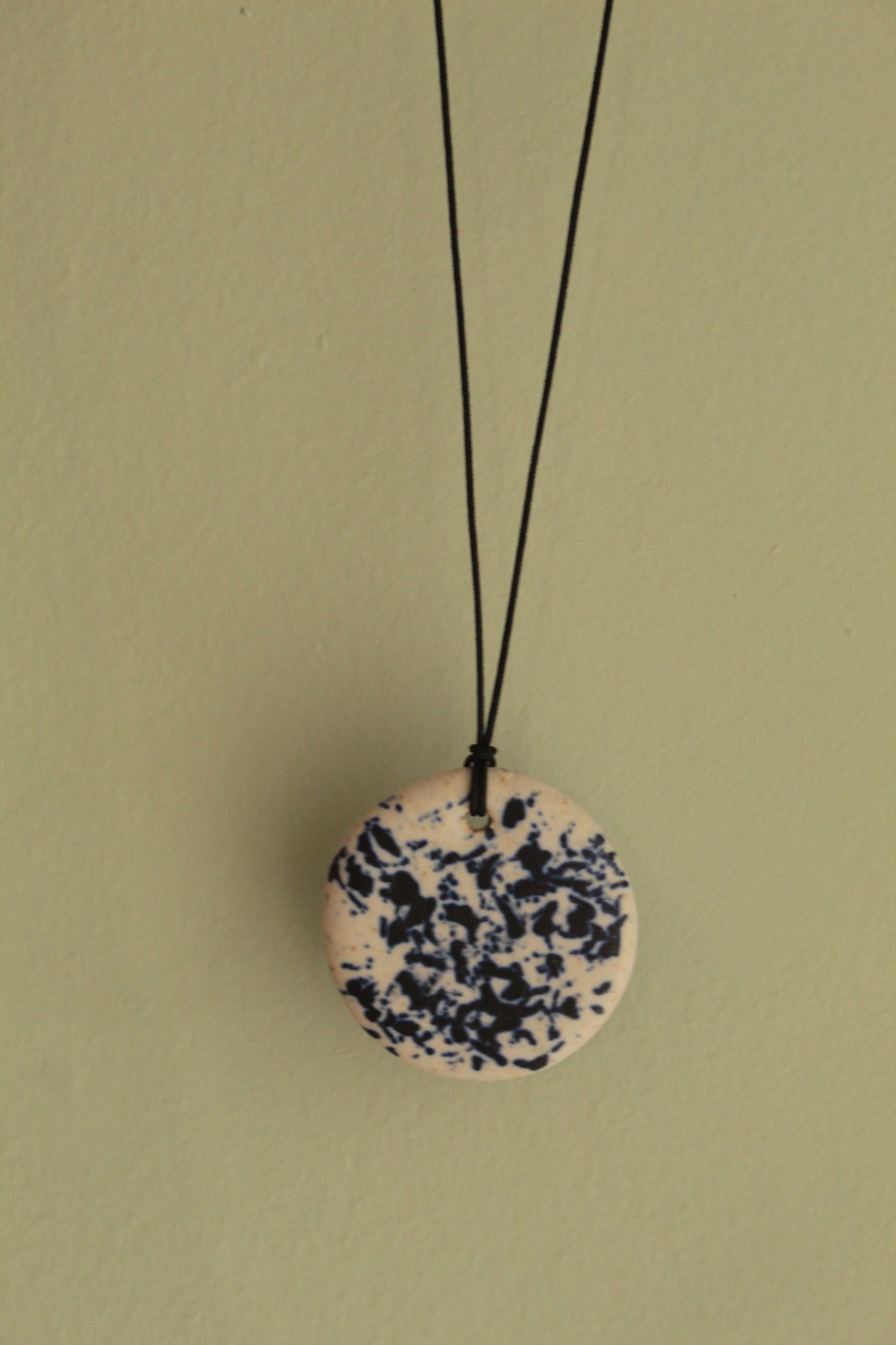 White with dark blue design circle necklace