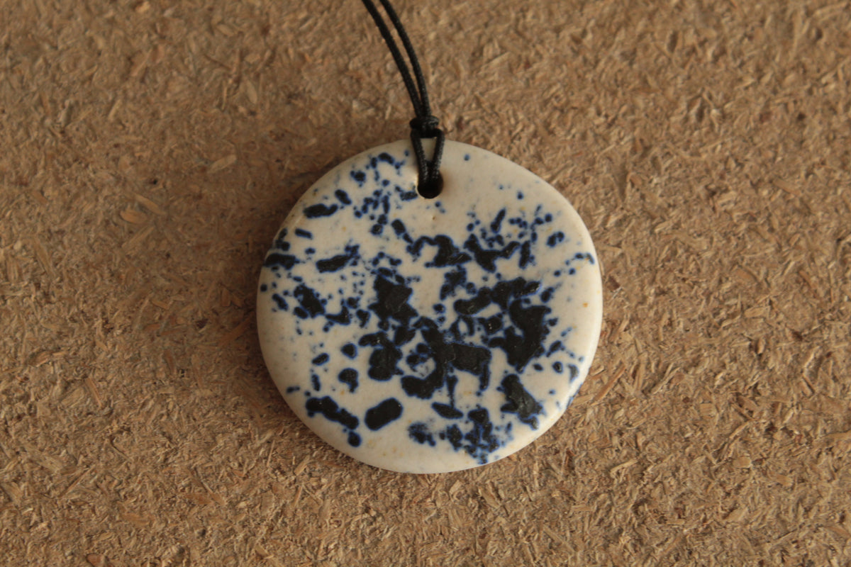 White with dark blue design circle necklace
