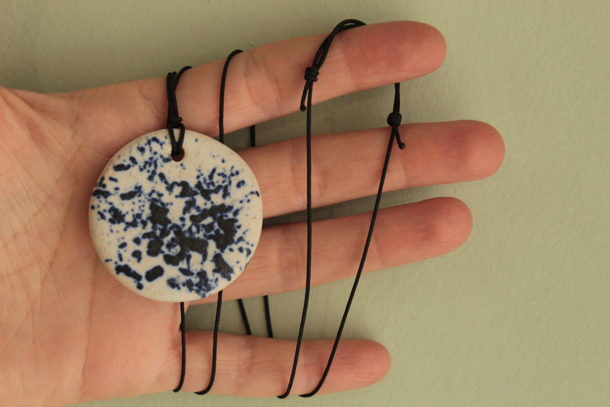 White with dark blue design circle necklace