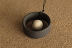 Black wheel and white stone necklace