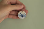 White with blue design circle dangling earrings