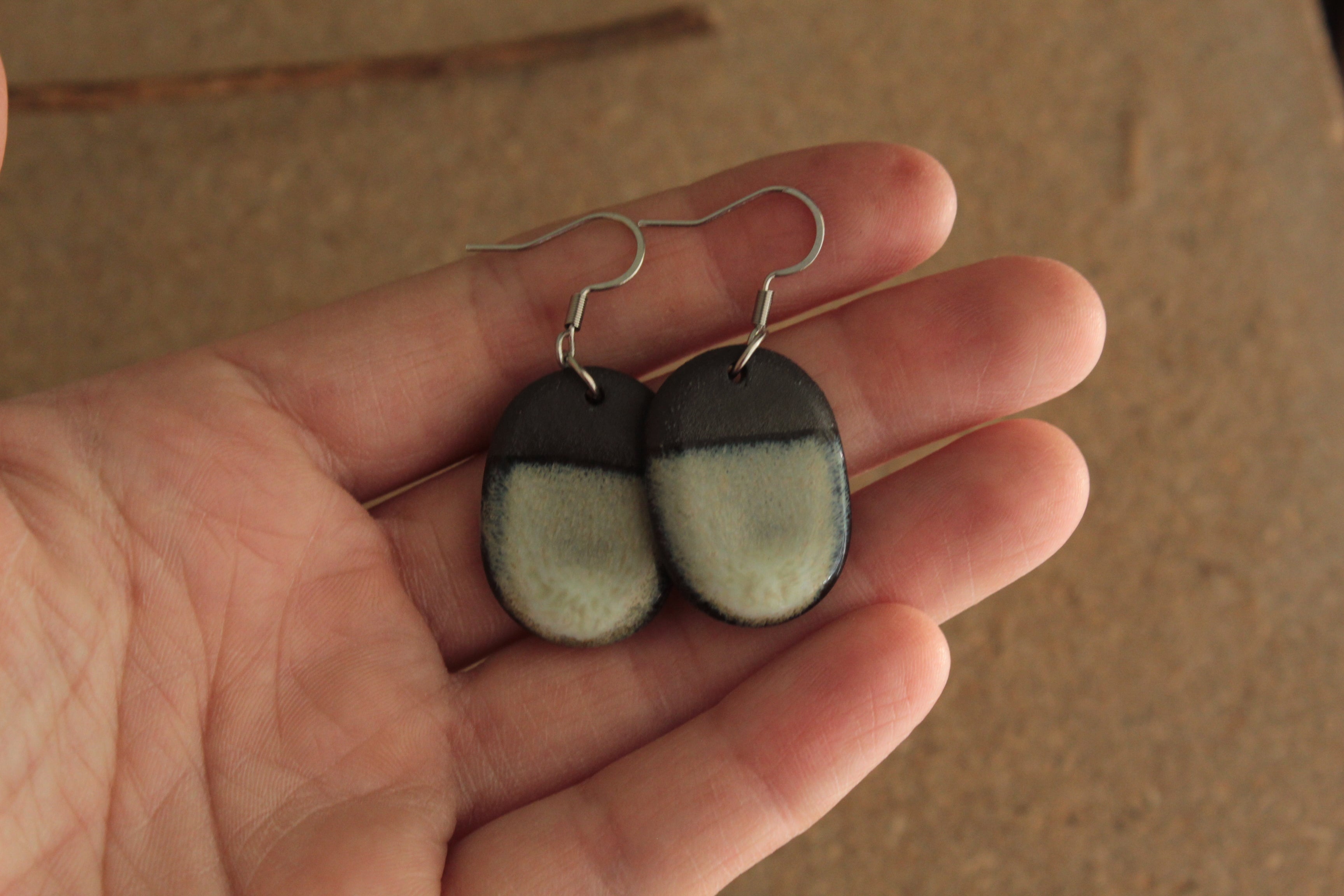 Black and beige oval dangling earrings