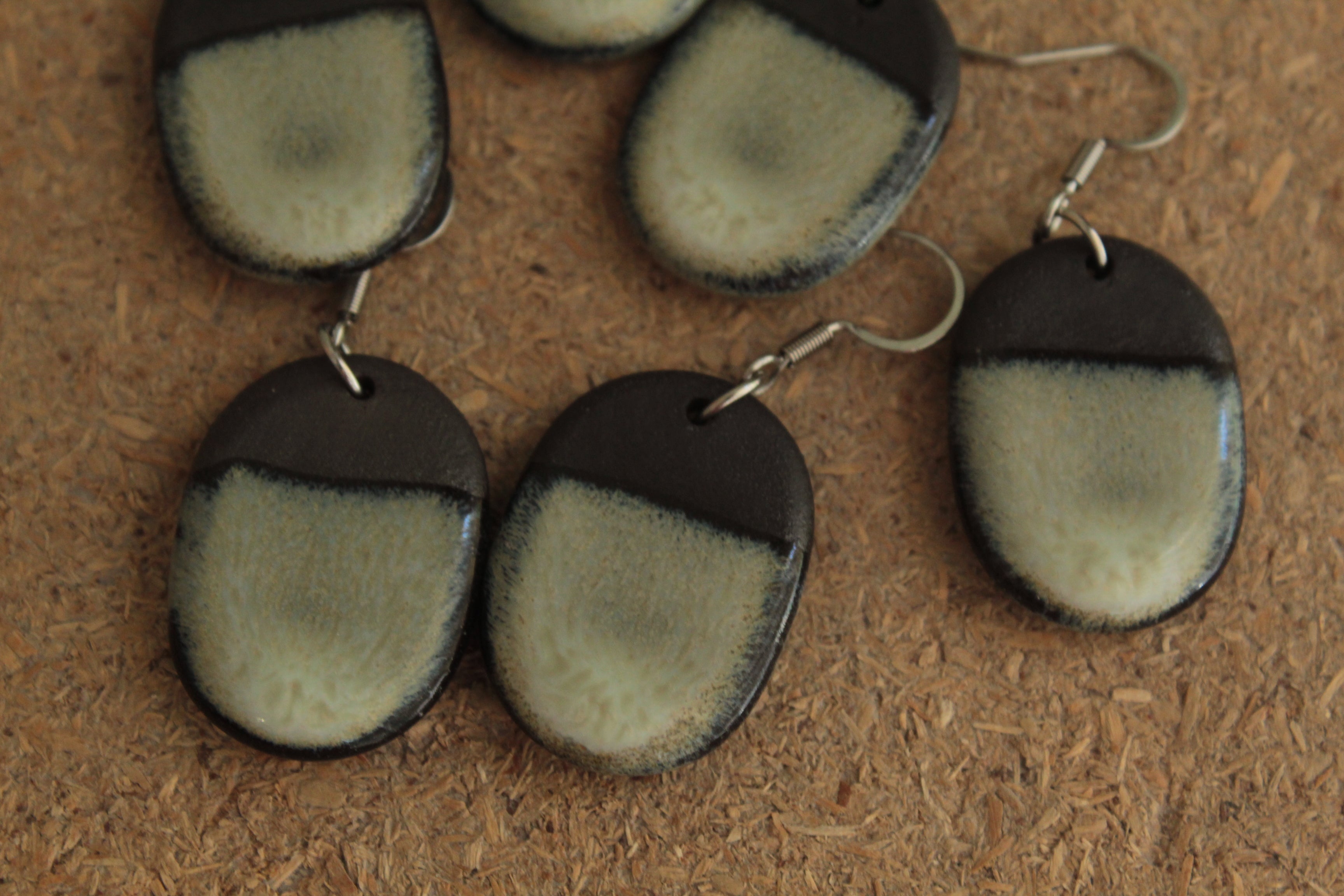 Black and beige oval dangling earrings