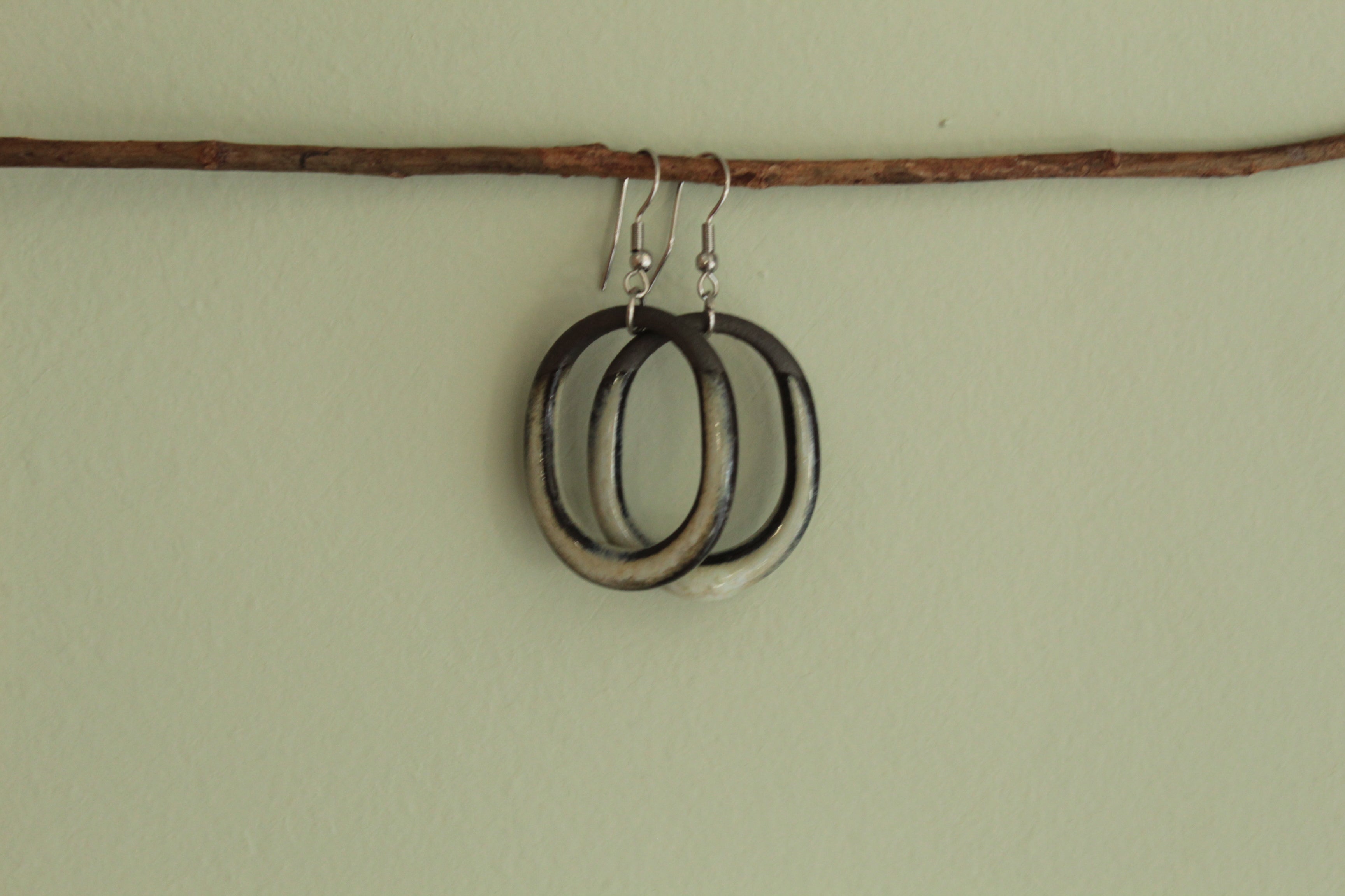 Black and beige oval hoop dangling earrings
