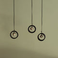 Black wheel and white stone necklace