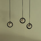 Black wheel and white stone necklace
