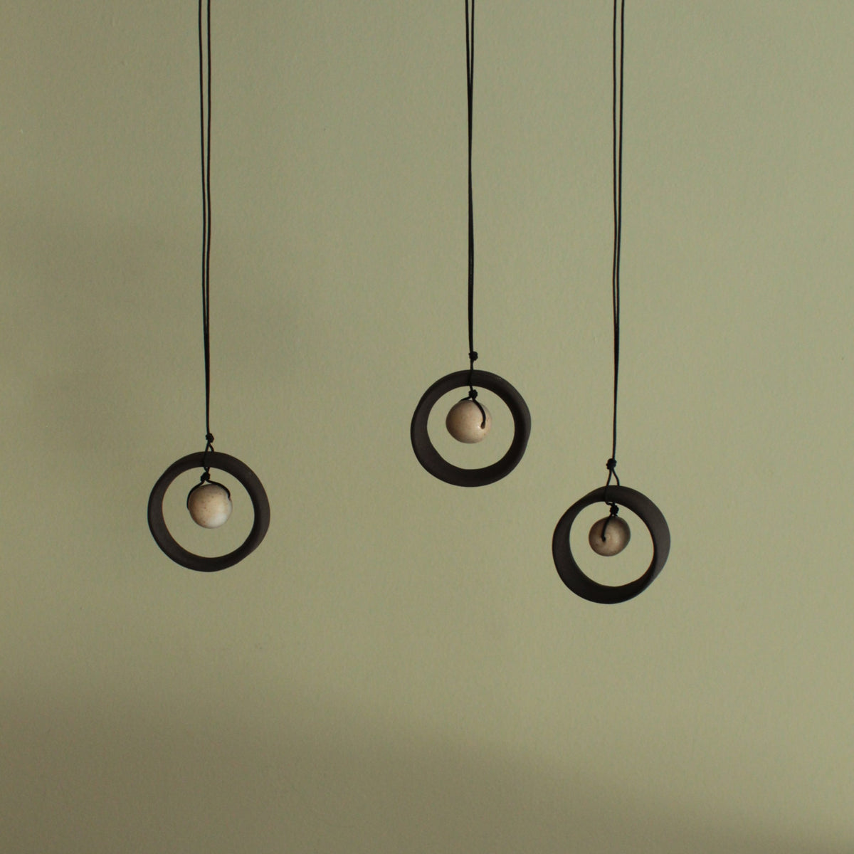 Black wheel and white stone necklace