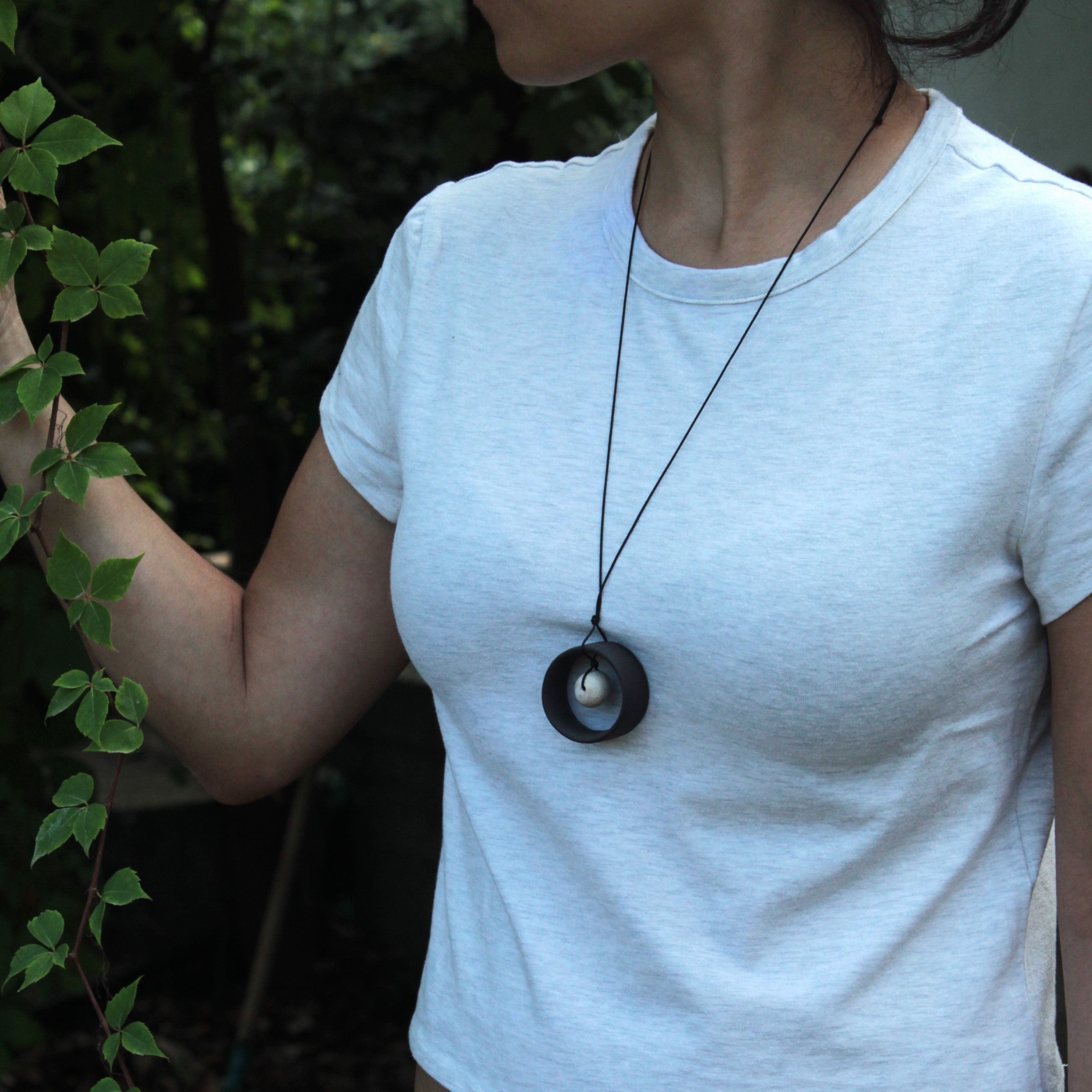 Black wheel and white stone necklace