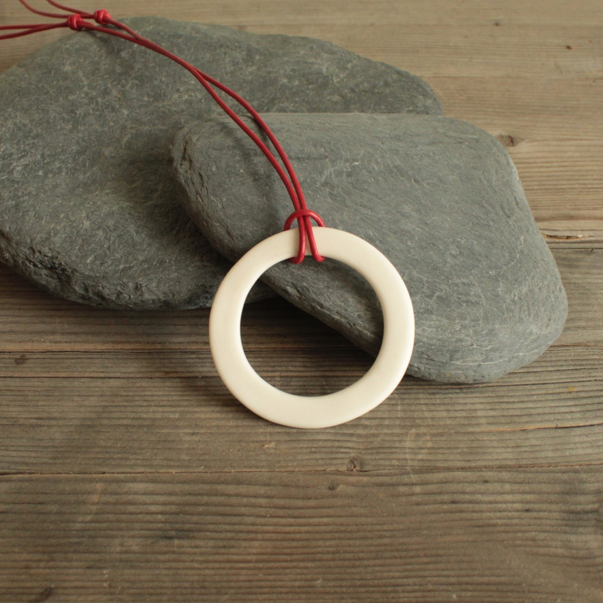 White hoop with red leather cord porcelain necklace