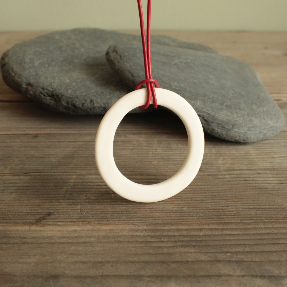 White hoop with red leather cord porcelain necklace