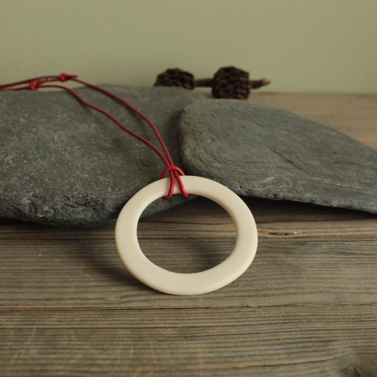 White hoop with red leather cord porcelain necklace