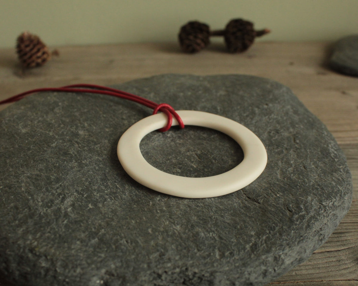 White hoop with red leather cord porcelain necklace
