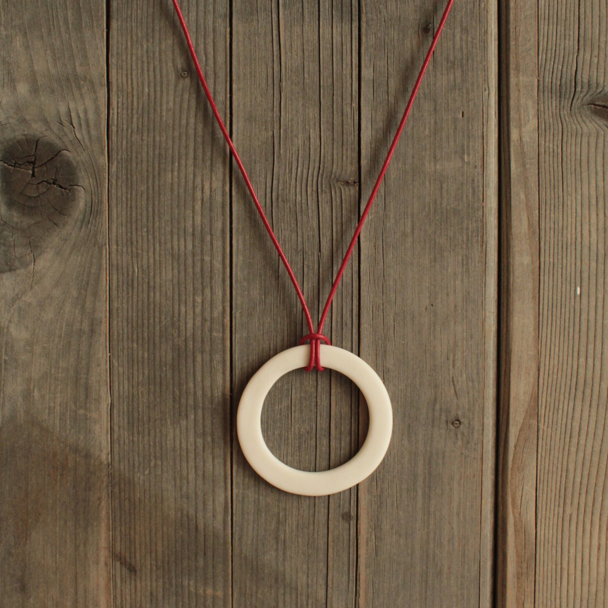 White hoop with red leather cord porcelain necklace