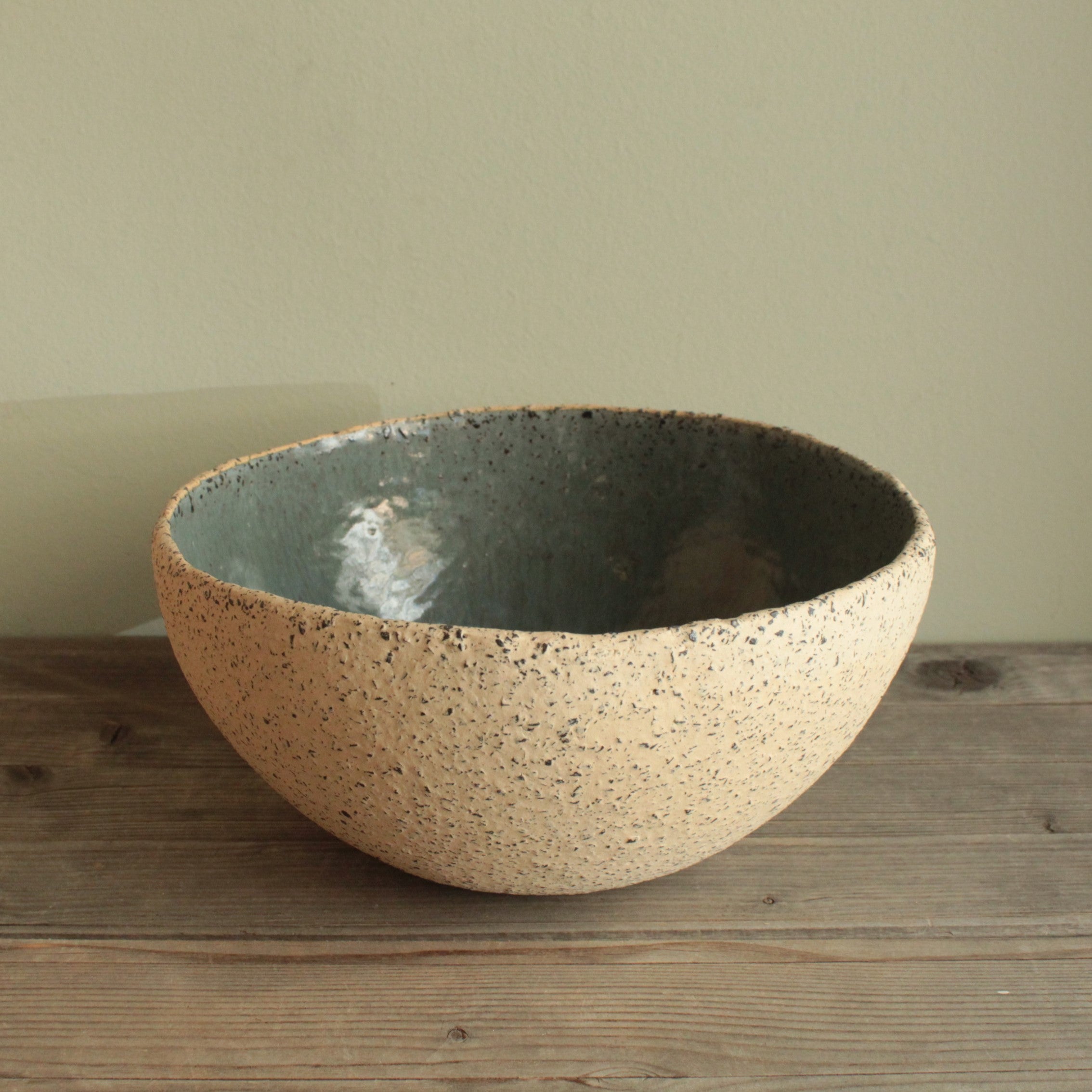 Beige bowl with ciel or green glaze