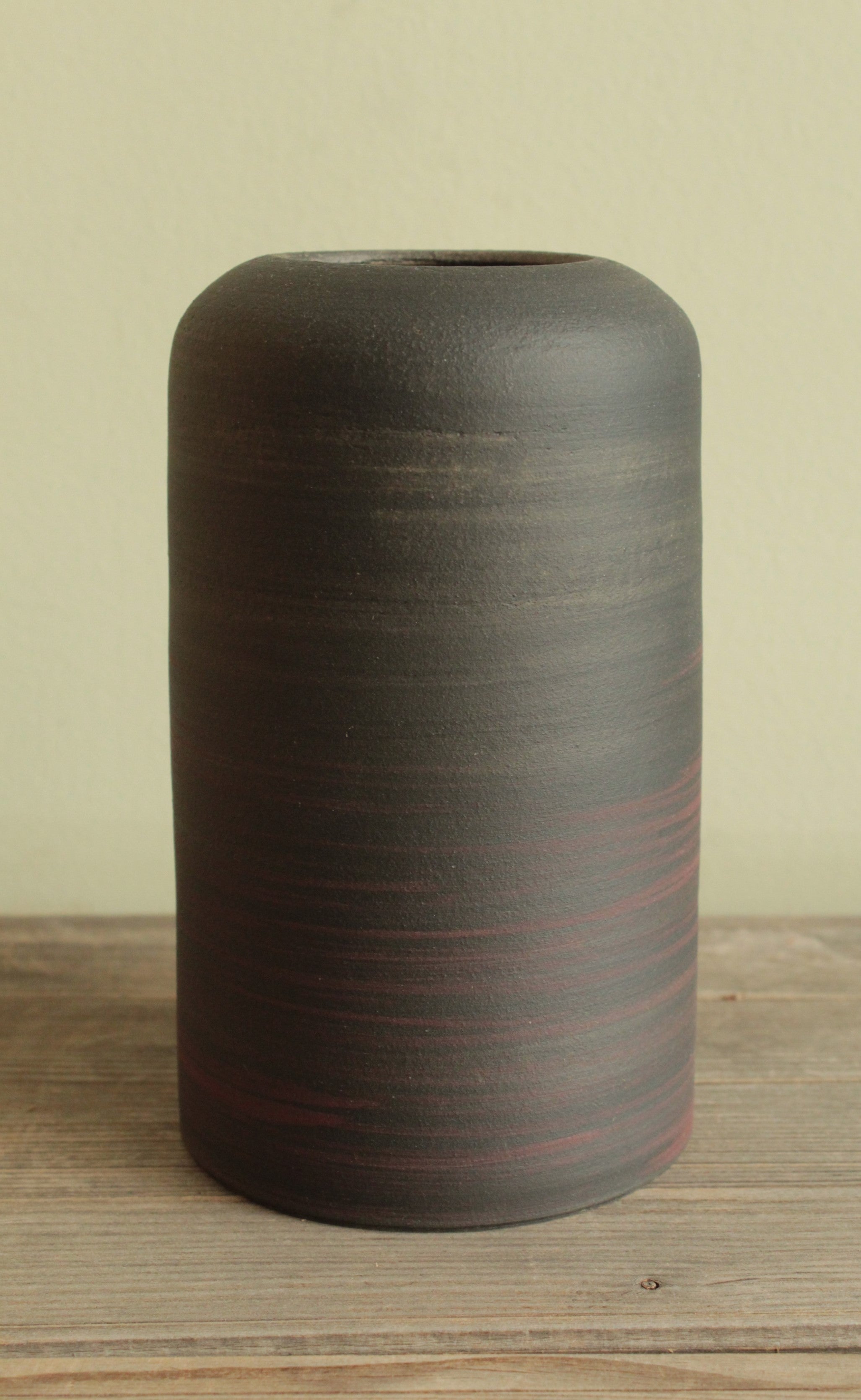 Black vase with red lines