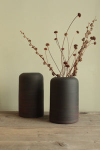 Black vase with red lines