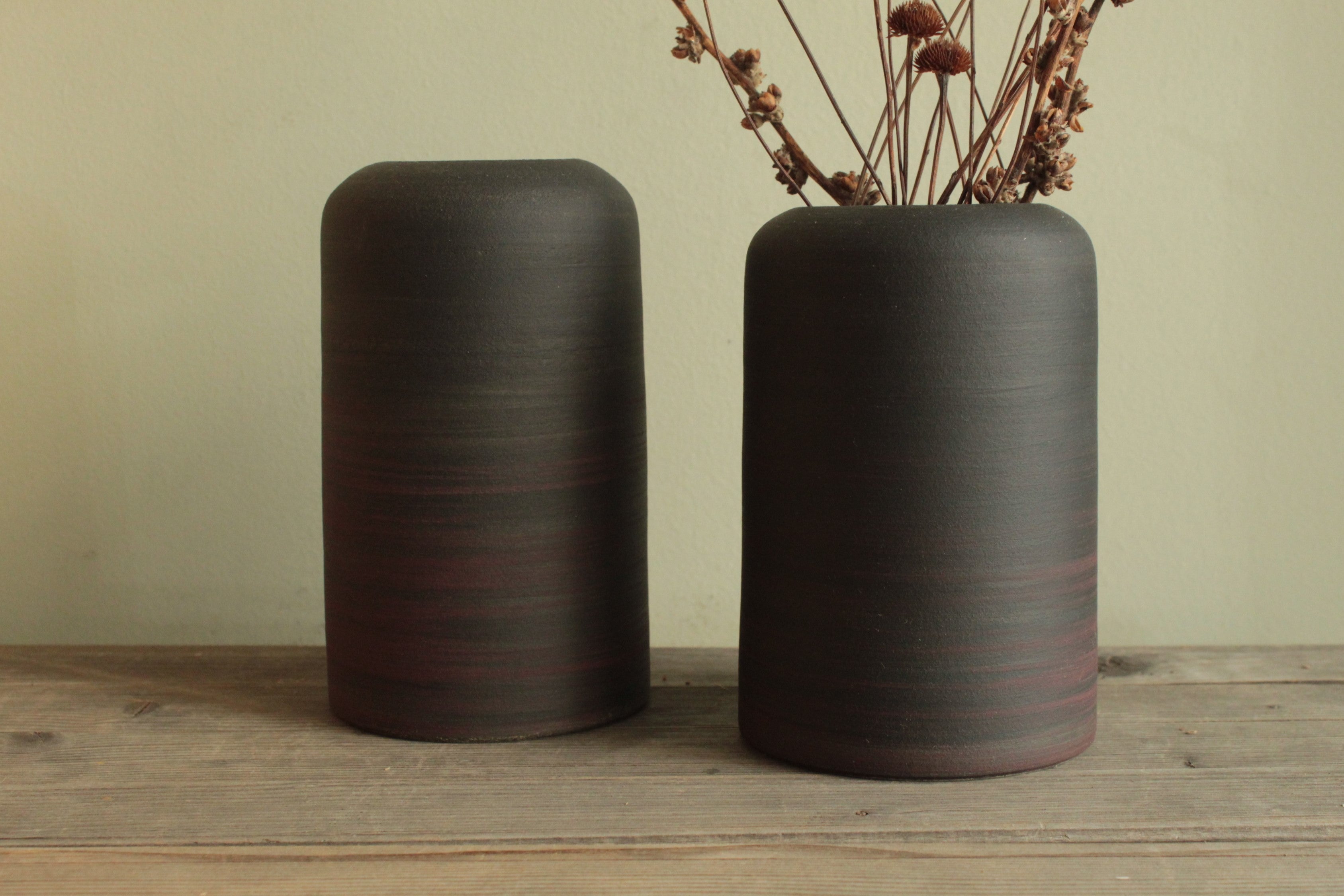 Black vase with red lines