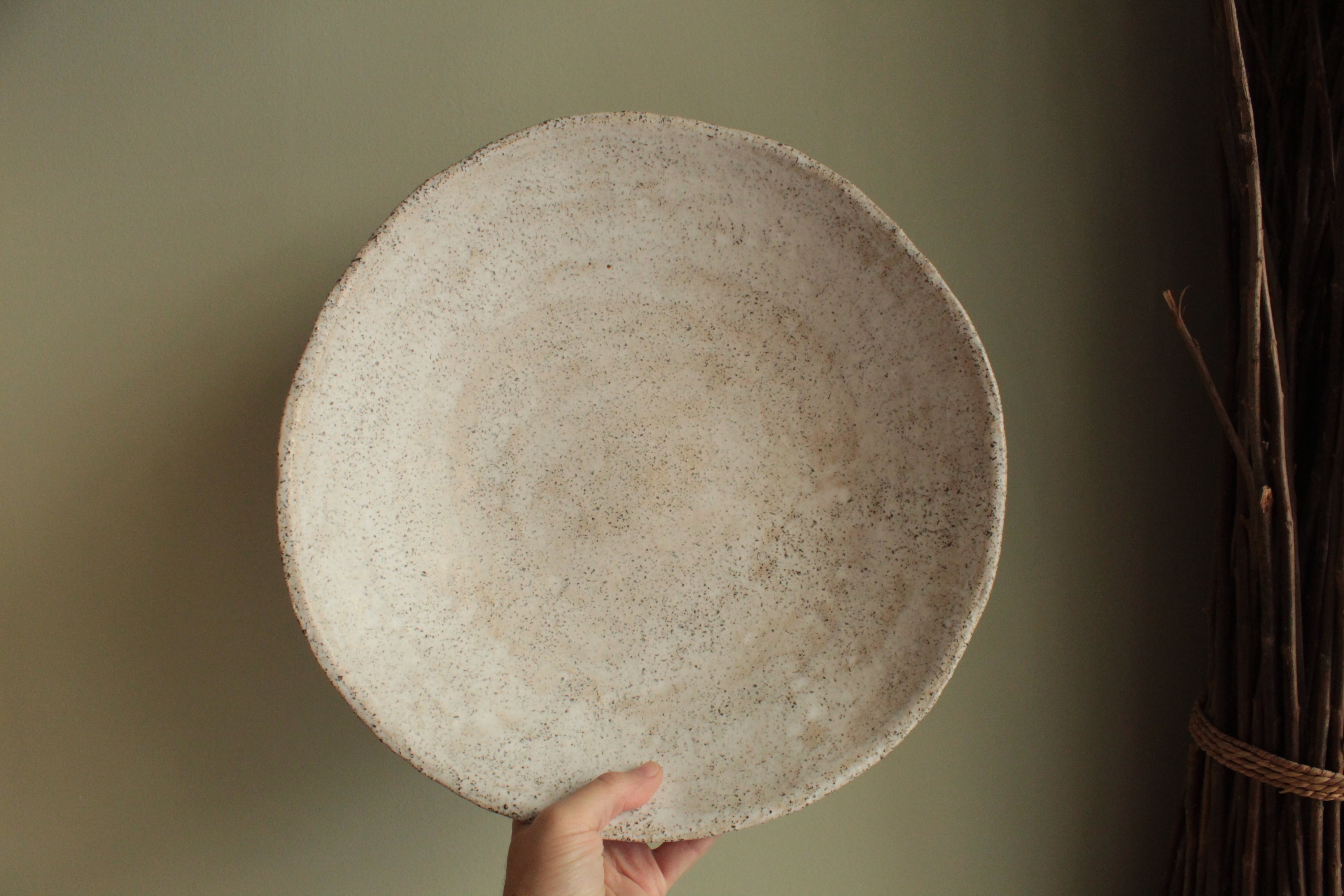 White platter/ bowl with black stones