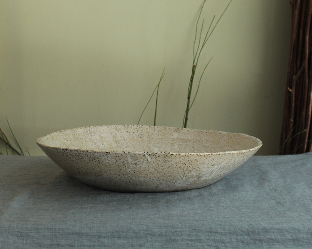 White platter/ bowl with black stones