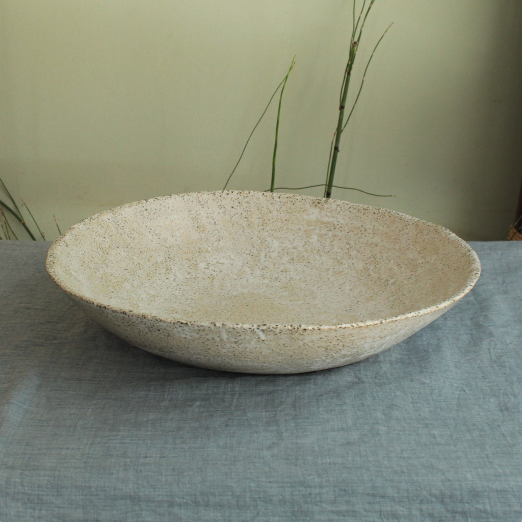 White platter/ bowl with black stones