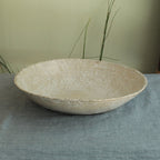White platter/ bowl with black stones