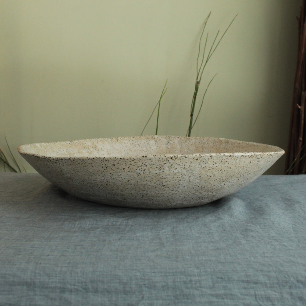 White platter/ bowl with black stones