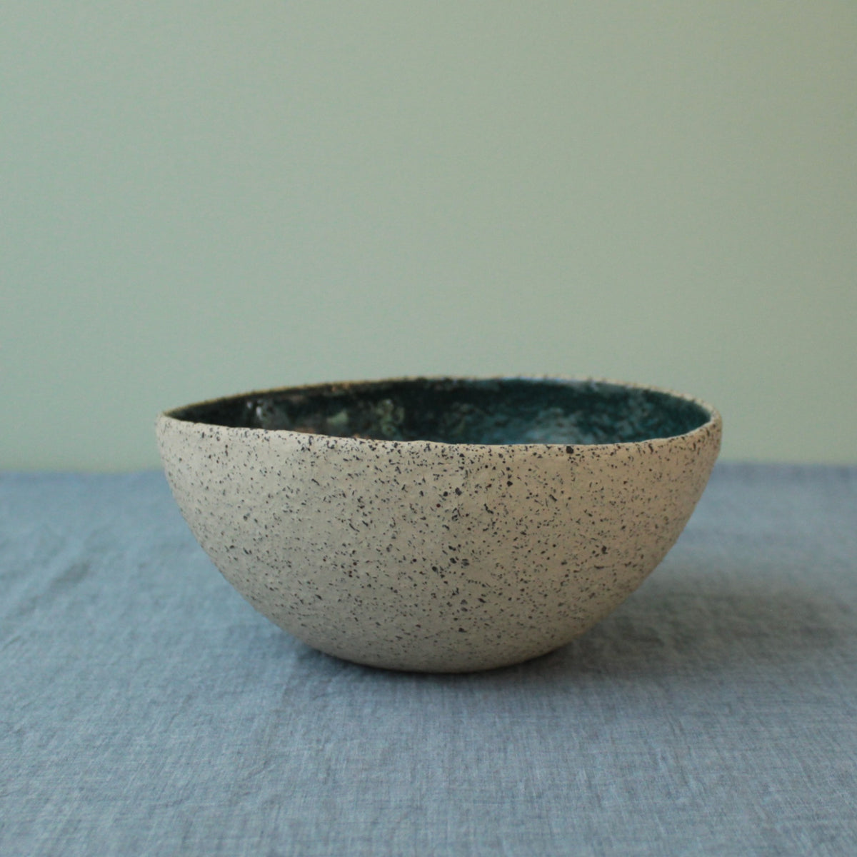 Beige bowl with botanical green glaze