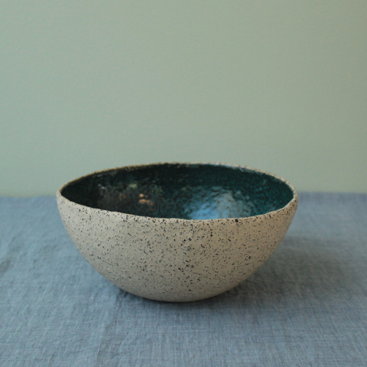 Beige bowl with botanical green glaze