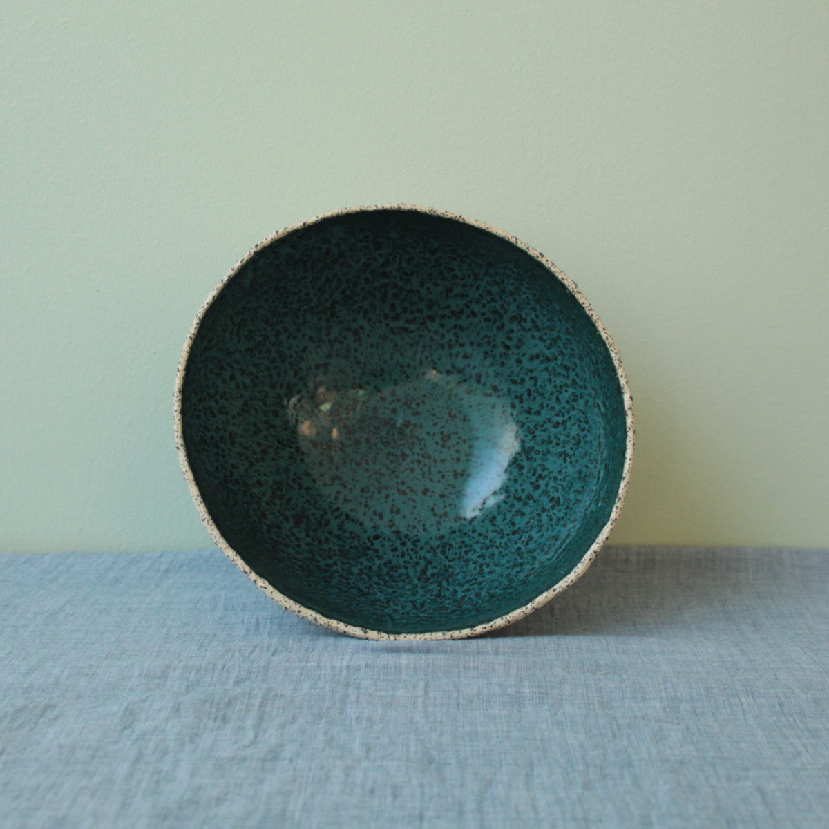 Beige bowl with botanical green glaze