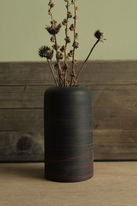 Black vase with red lines