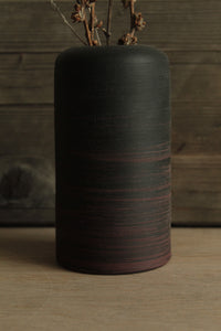 Black vase with red lines