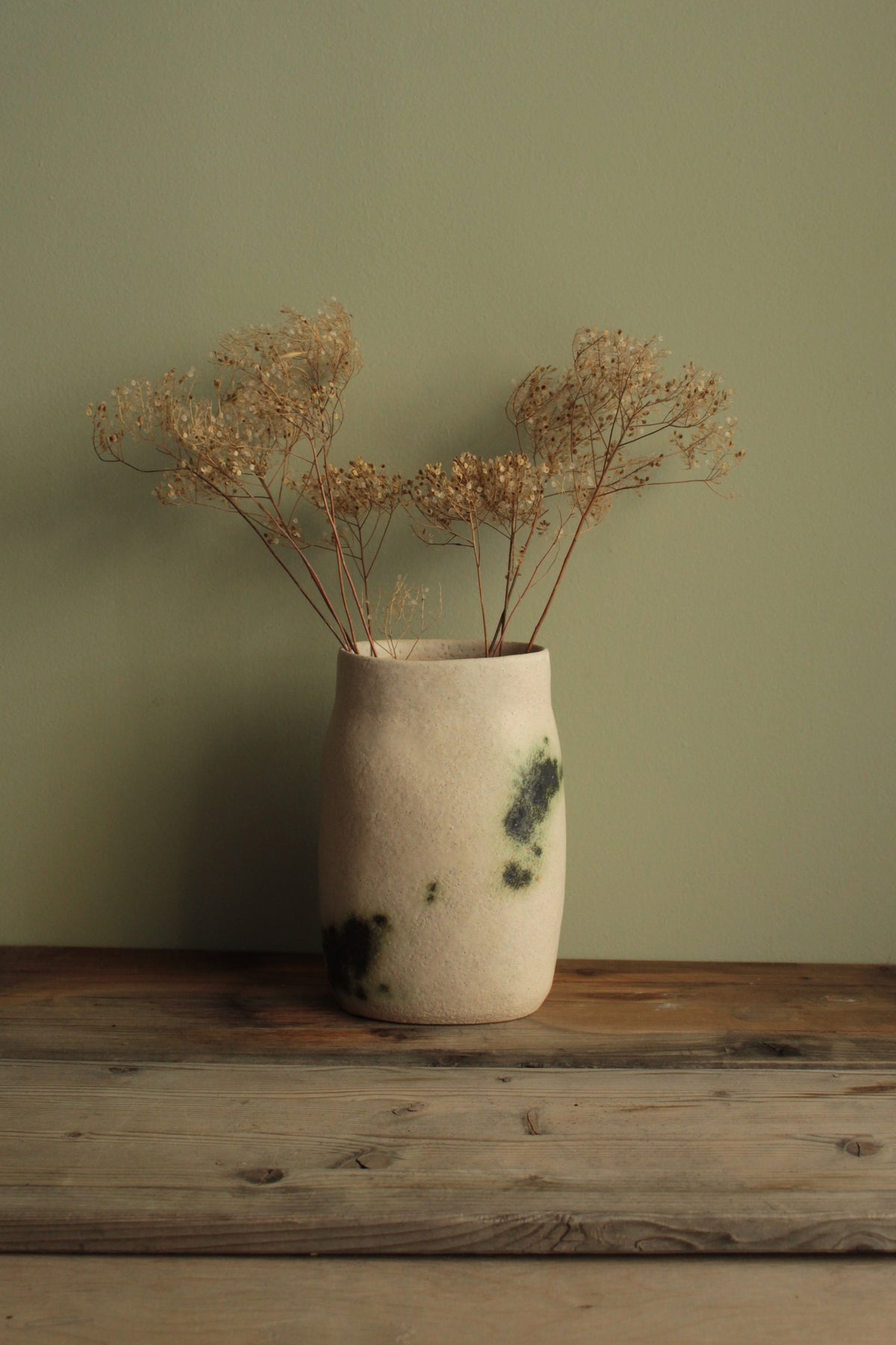 White vase with green design