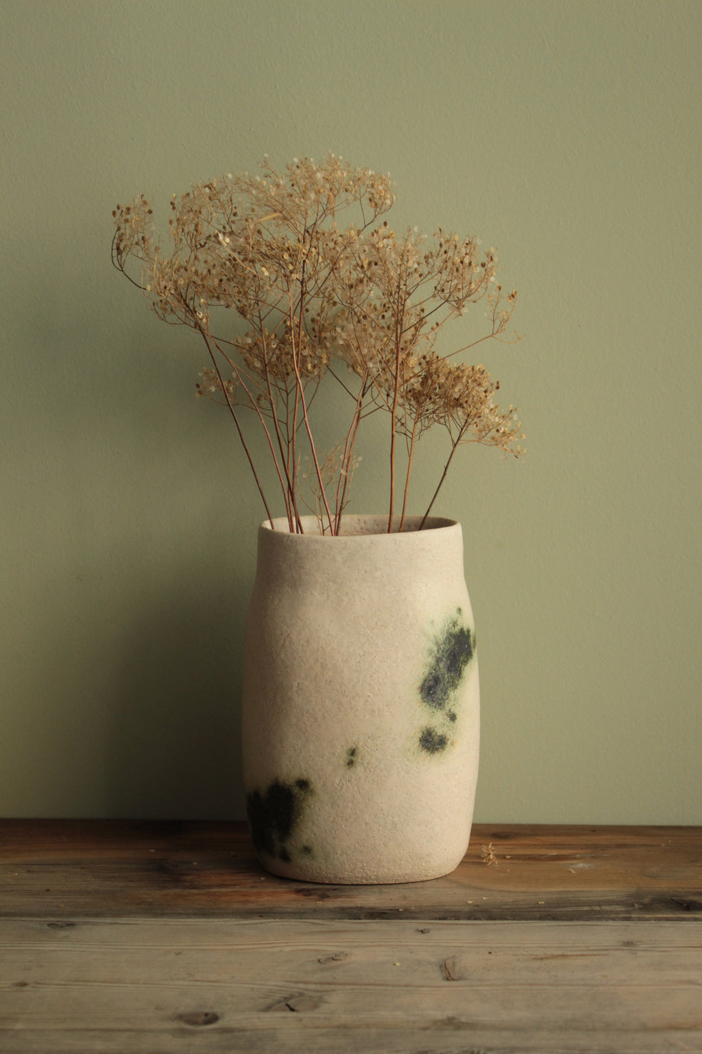 White vase with green design