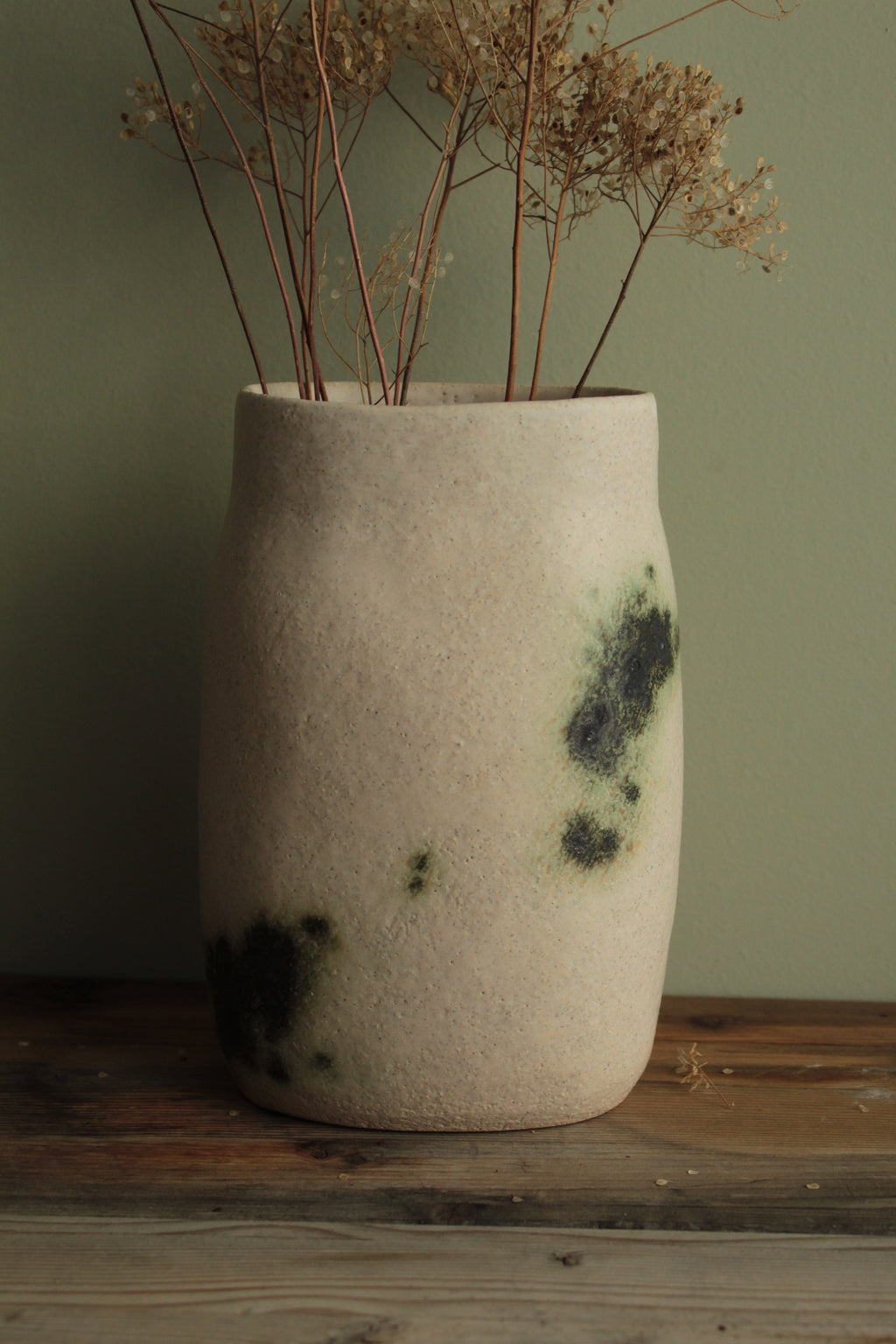 White vase with green design