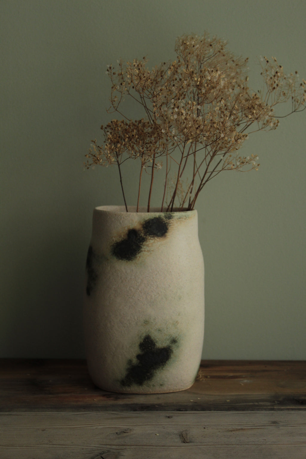 White vase with green design